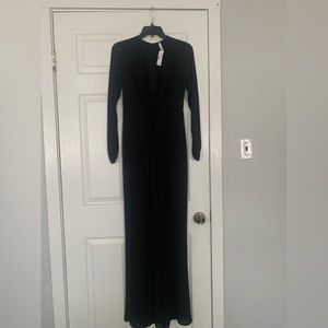 Deep V neck black jumpsuit .  Size small .  Flare legs.  Never worn .